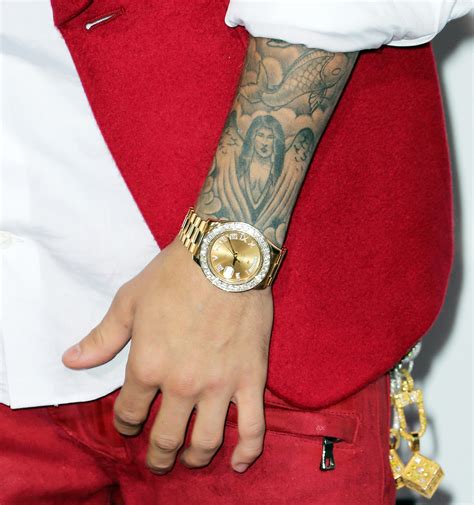 Justin Bieber's Selena Gomez Portrait Tattoo When speaking with GQ in 2016 , Bieber shared that the angelic woman tattooed on his left forearm is the portrait of his ex-girlfriend Selena Gomez .